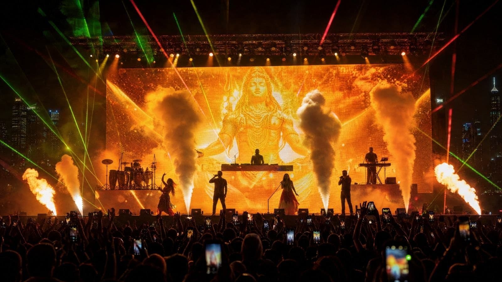 Bhakti X live: performers in front of a golden Shiva projection with pyrotechnics